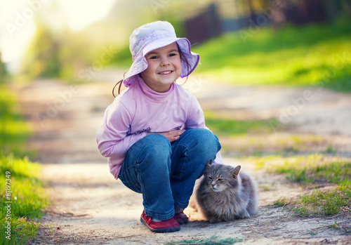 Little girl with cat outdors