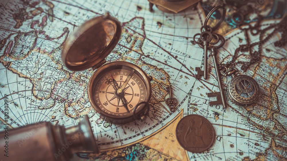 Old collection compass, telescope and collecting rare items on antique world map. (vintage style) 