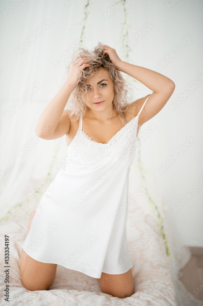 Curly Blonde Girl In A White Silk Gown Boudoir Robe On Bed Stock Photo Adobe Stock