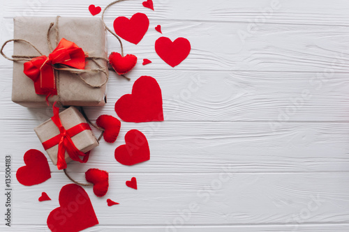 Valentine's Day. presents, heart felt and decor on wooden background