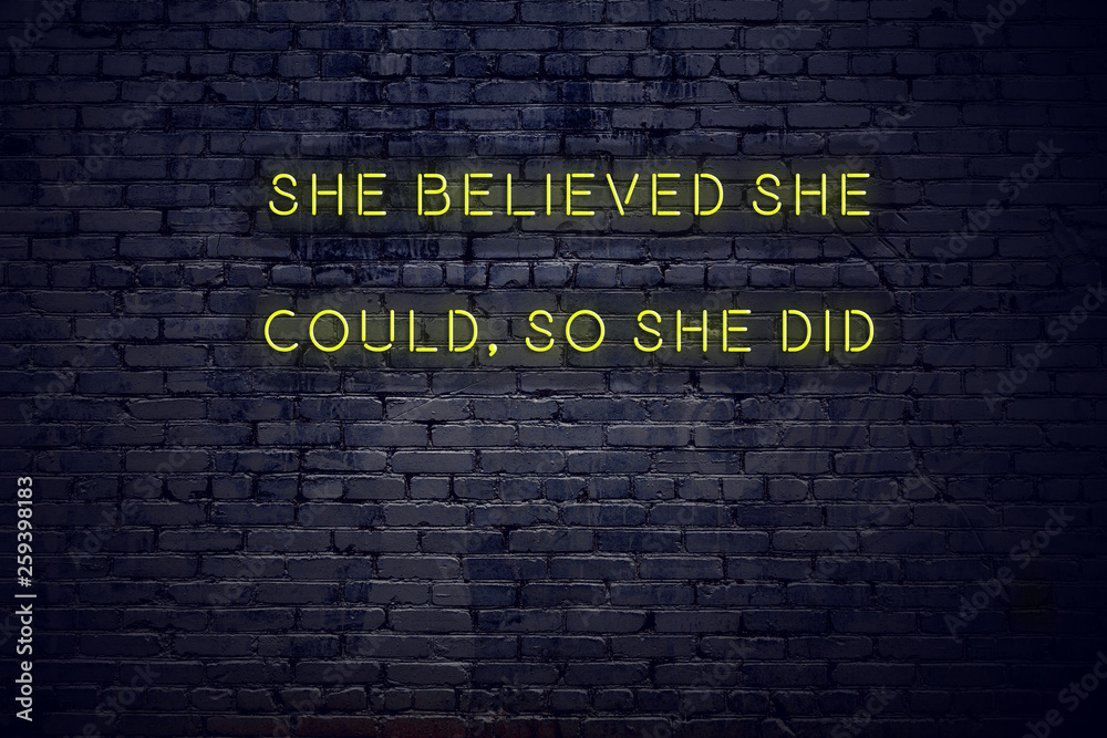 Positive Inspiring Quote On Neon Sign Against Brick Wall She Believed