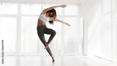 Girl Training Contemp In Modern Dance Studio. Copy Space