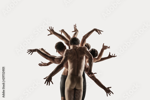 The group of modern ballet dancers. Contemporary art ballet. Young flexible athletic men and women in ballet tights. Studio shot isolated on white background. Negative space.