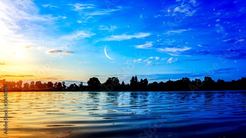 The romantic moon over water . Crescent moon with beautiful sunset background . Generous Ramadan . New moon.