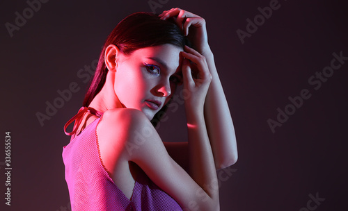Toned portrait of beautiful young woman on dark background