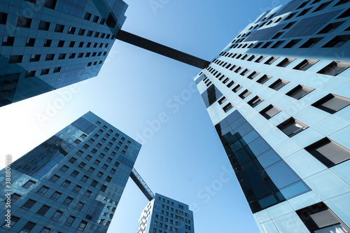 four connected business buildings pretty blue skyscrapers with square bridges windows blue sky upward view