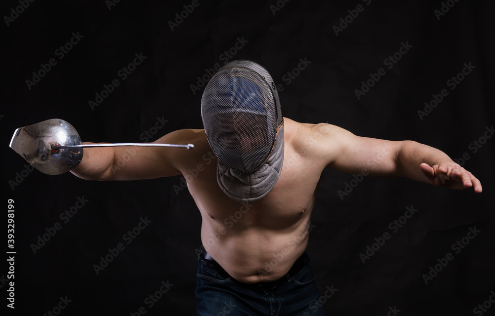 Matured Man With Naked Muscular Torso In Fencing Helmet And Epee Stock