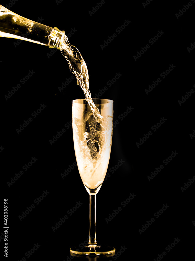 Champagne Pouring Into An Empty Glass On A Black Background Stock