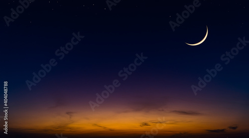 Dusk sky with crescent moon and stars