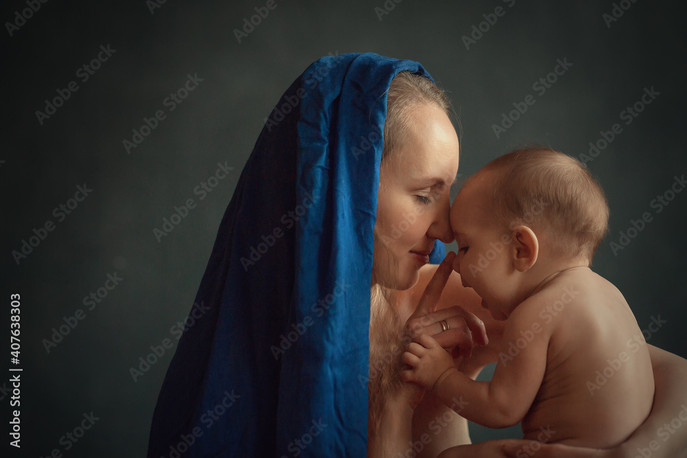Beautiful Long Haired Mother In Red And Blue Dresses With A Naked Baby Looks Like Madonna Image