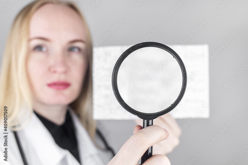 A Neurologist With A Magnifying Glass Examines An Encephalogram Of A