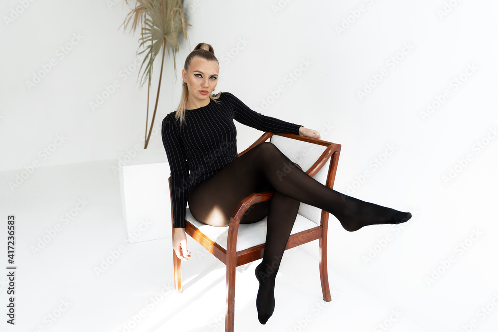 Fashion Model In Black Tights On The White Background Hot Blonde Girl With Long Legs In