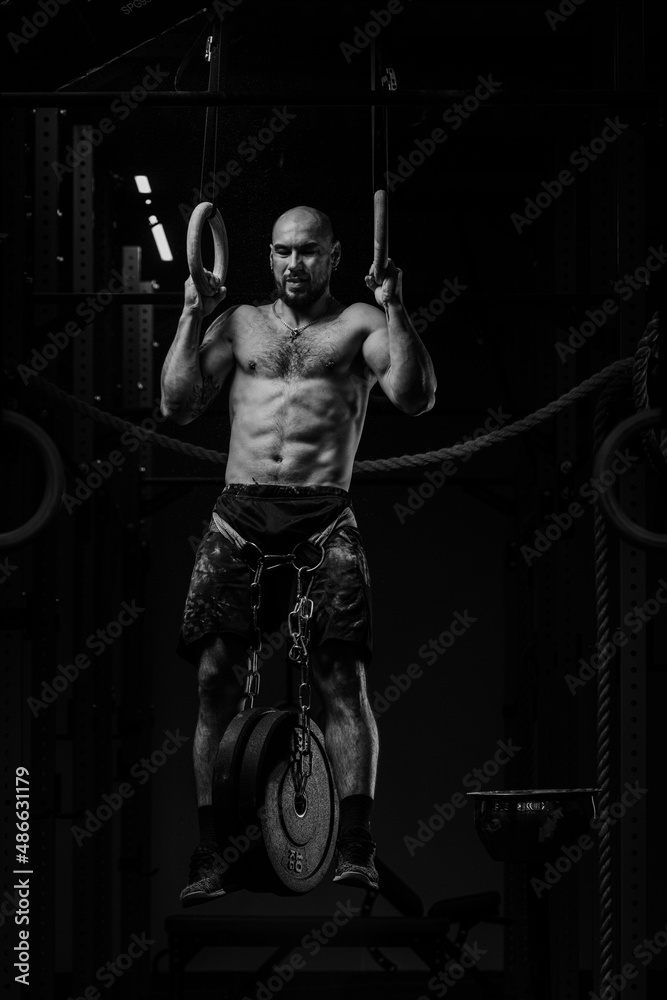 Crossfit Athlete With Naked Torso Doing Heavy Pull Ups Stock Photo