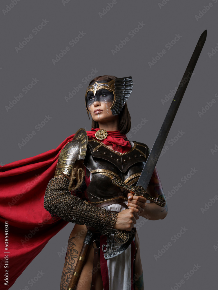 Shot Of Female Barbarian Holding Sword Dressed In Steel Armor With