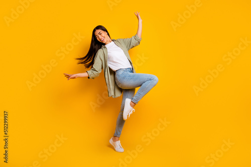 Full length portrait of overjoyed gorgeous lady enjoy dancing partying isolated on yellow color background