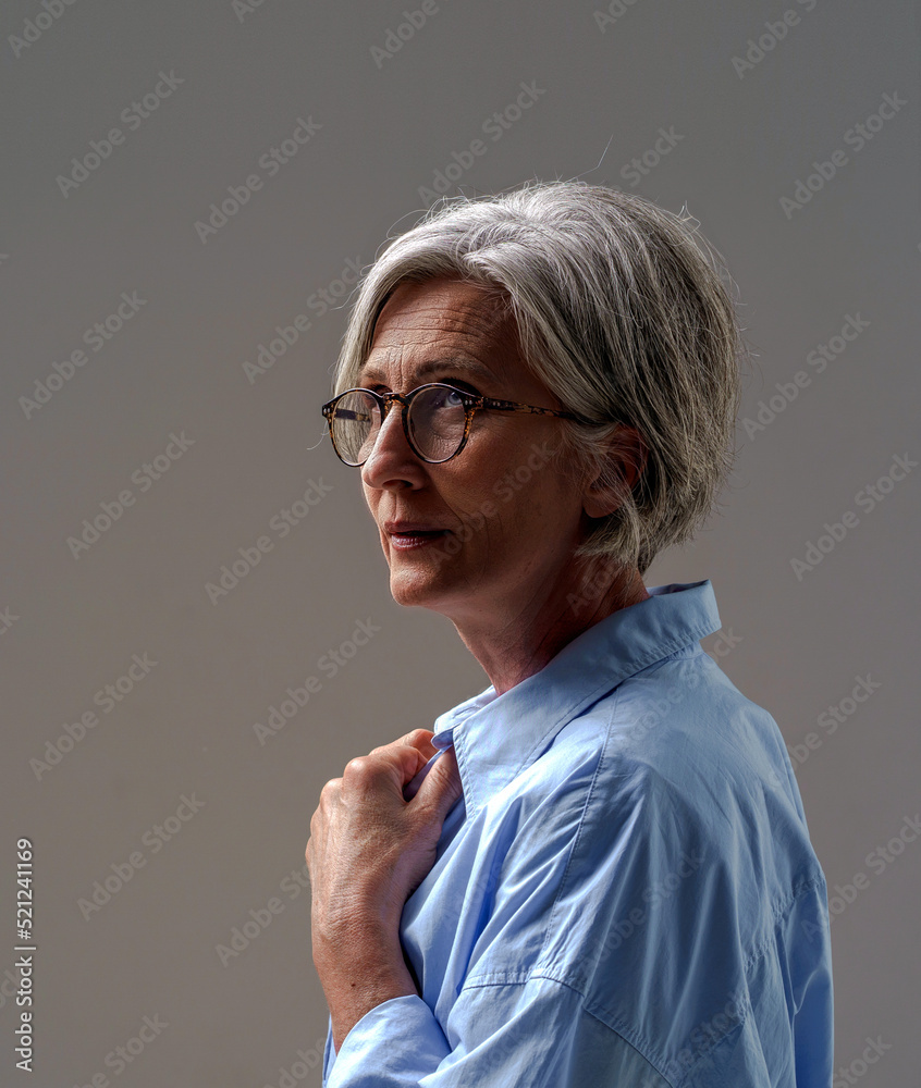 Grey Haired Mature Woman Studio Shot In Low Light Dramatic Portrait Of