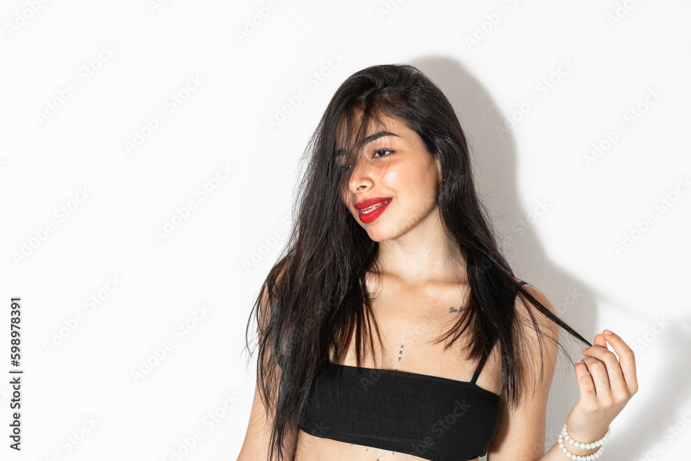 Beautiful Latina Woman Posing On A White Background With A Charismatic Smile And A Distracted