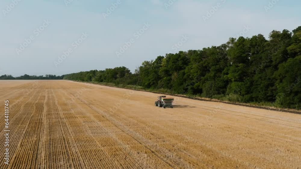 Aerial View Of Farmer Fertilizing Agricultural Field Spreading Mineral