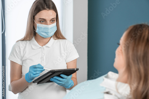 A female dentist who impresses with her professionalism and determination, serves her patients in a cozy dental office. Her care and attentiveness ensure a high standard of treatment.