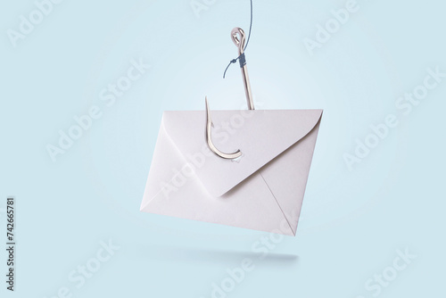 Paper mail letter with metal hook on blue pastel background, concept. Phishing and hacker attack via email, creative idea. Hackers and spam mailing. Data theft. Trap and deception