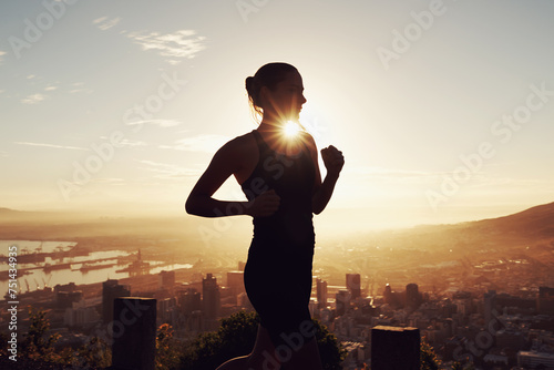 Fitness, running and woman in silhouette on mountain for health, wellness and strong body development. Workout, exercise and girl runner on sunset path in nature for training, performance and city