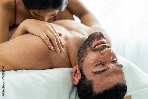 Close up of man and woman starting foreplay and making love on bed. 