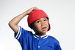 confused kid in red baseball cap