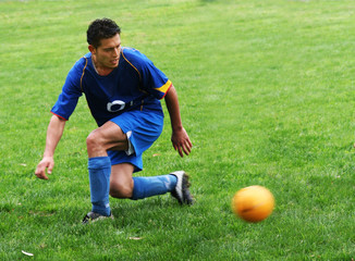 Canvas Print - soccer player hitting a ball