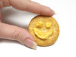 holding a cracker with a smile
