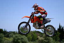 Red And Orange Moto X Or Motor Cross Bike Giving Big Air On Dirt