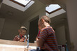 © Mehmet Dilsiz - little boy brushing his teeth in front of a mirror