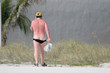 sunburnt man walking on beach