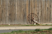 Wagon Wheel Against Wood Fence