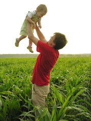 father with baby in field