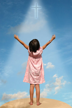 child with arms extended toward heaven