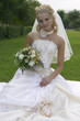 © Roman White - the fine bride sits on a meadow.