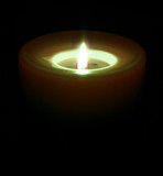Fototapeta  - orange candle in the dark