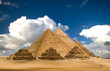 Leinwandbild Motiv pyramids and clouds