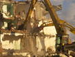demoliton - bulldozers tearing a building
