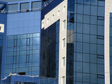 Building With Blue Mirrored Windows And White Wall