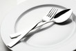© Tomo Jesenicnik - fork and spoon on white plate