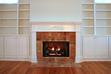 Lit Fireplace With Built In Bookshelves