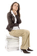 woman sitting on the heap of files - thinking