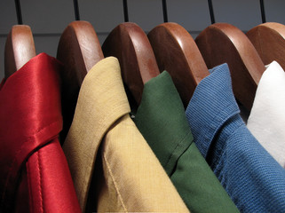 colourful shirts on wooden hangers