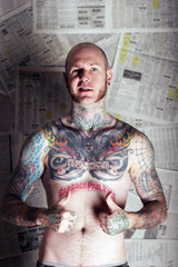 Wall Mural - tattoo man in front of newspapers