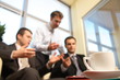 © endostock - young business men talking in an office - blur