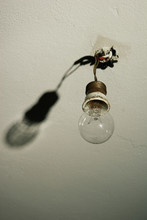 Light Bulb Hanging From Bare Wires