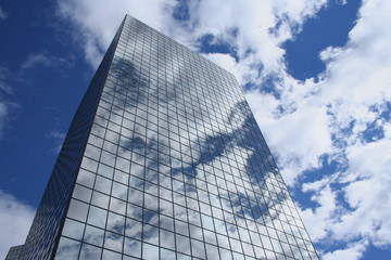 reflection of clouds and sky in modern skyscraper