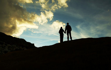 Canvas Print - boy and girl silhouette on sunset