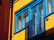 Blue Window In Yellow Brick Wall